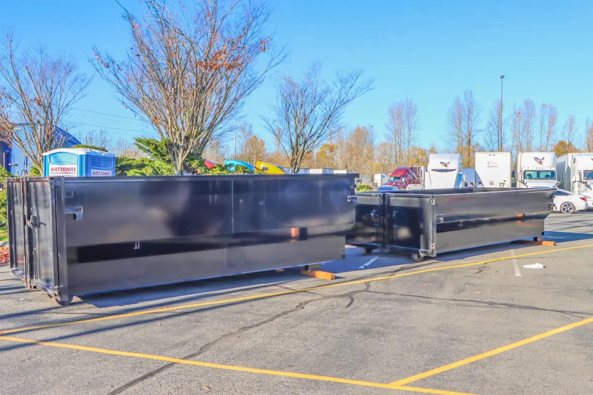 Professional dumpster rental service with roll-off container on residential driveway in Thief River Falls